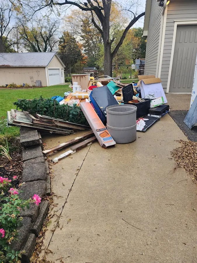 Dumpster being loaded with debris for 12 Yard Dumpster Rental in Morgan City